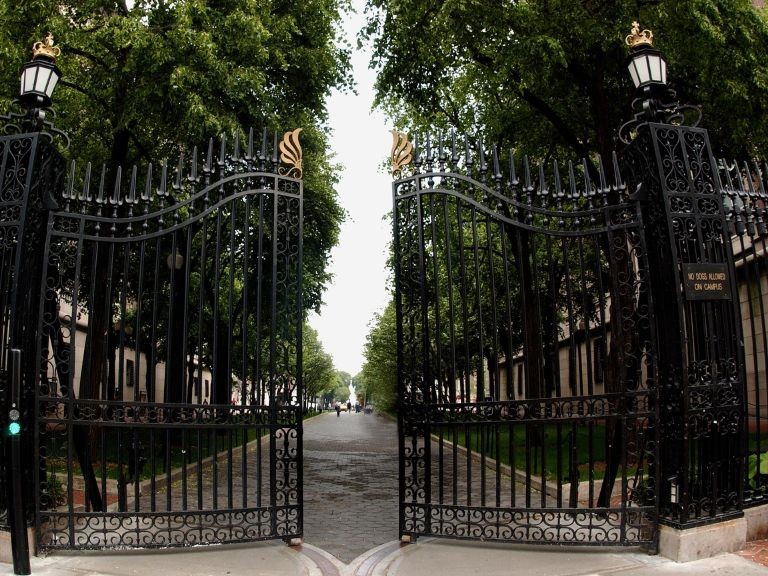 Gates to Morningside campus open against green trees and grey sky