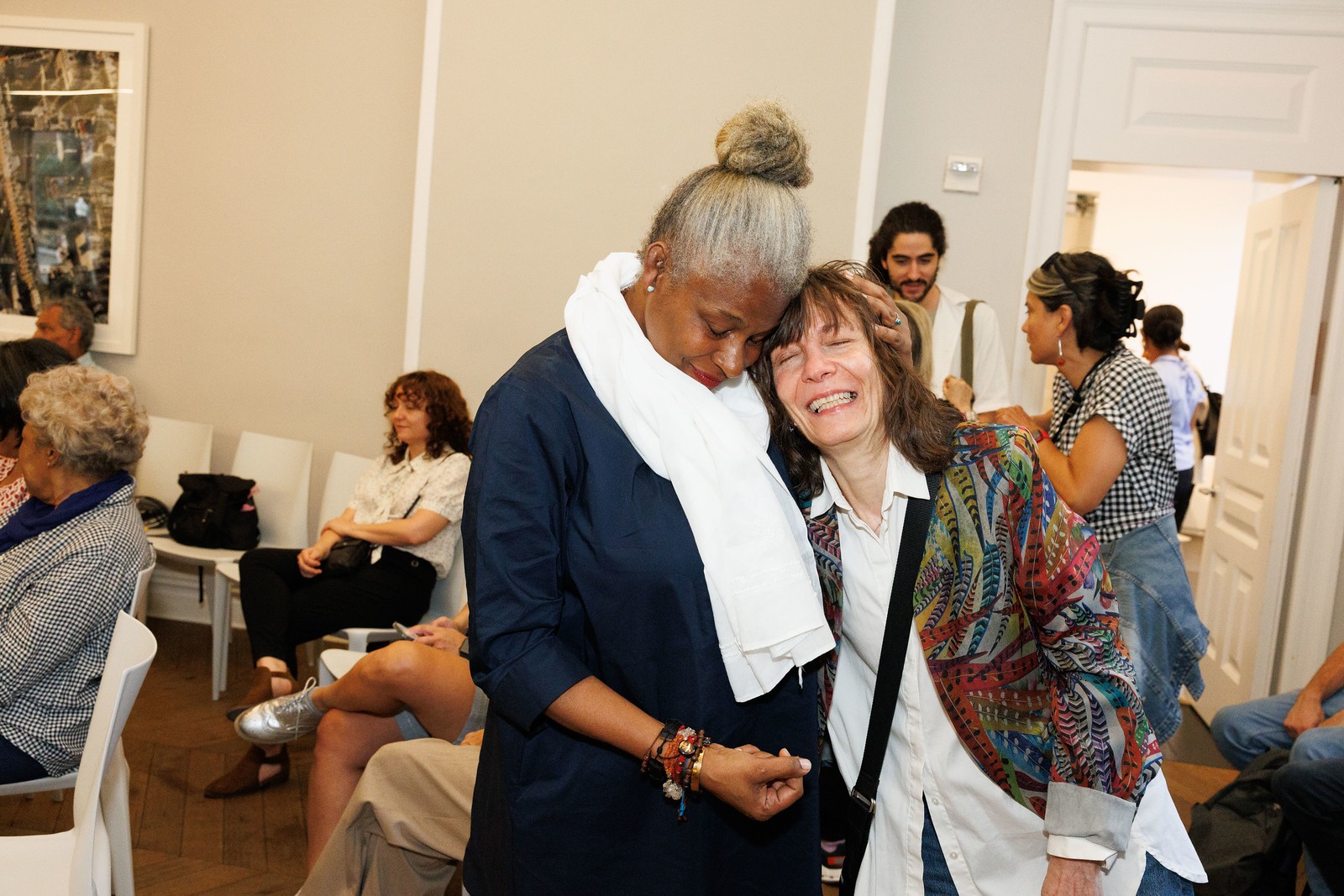 Josefina Baez standing and hugging a woman