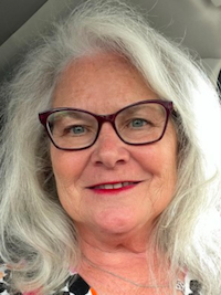 Head shot of Shawn Morehead with shoulder length white hair and glasses