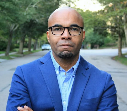 Photo of Mario Small wearing black glasses, a blue blazer, and a blue collared shirt