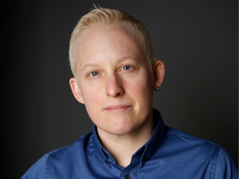 Head shot of Tey Meadow with short blonde hair and a blue collared shirt