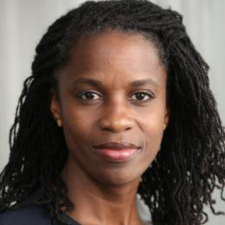 Head shot of Olatunde Johnson with shoulder length hair