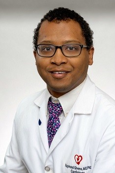 Headshot of Raymond Givens wearing lab coat and purple tie