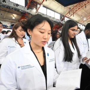 Diverse students in white coats at their White Coat Ceremony