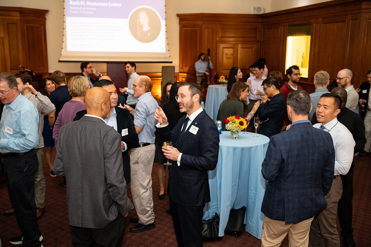 The Office of the Provost hosted newly tenured faculty, their families, senior leadership, and the Tenure Review Advisory Committee, at a well-attended reception in Low Library recognizing faculty who were awarded tenure in 2022. Crowded room of men and women in business casual attire