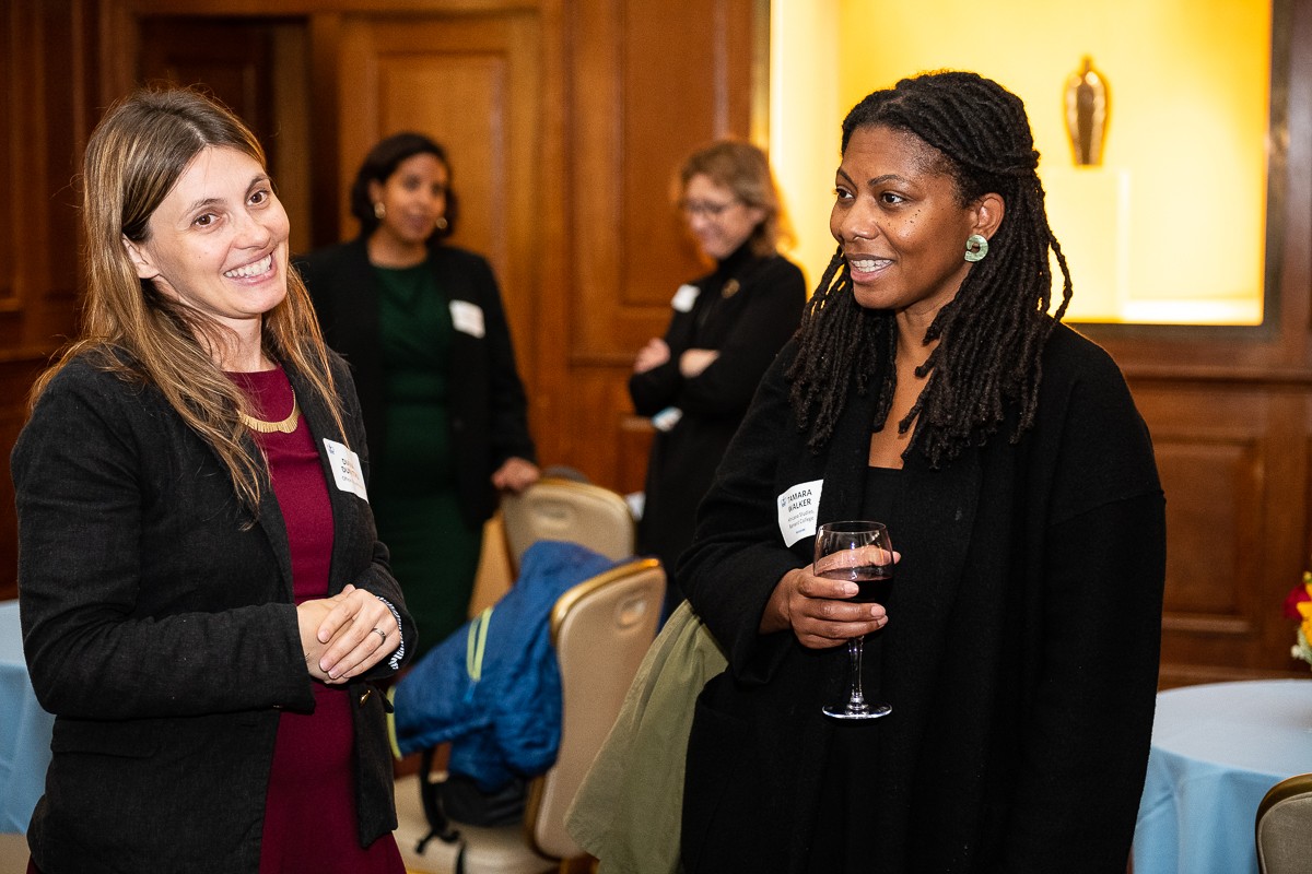 Left to Right: Diana Dumitru, Associate Director of Inclusive Faculty Pathways, speaks with Tamara J. Walker, Associate Professor of Africana Studies at Barnard College, who recently joined Columbia's faculty with tenure. Two women smiling with two other women in the background