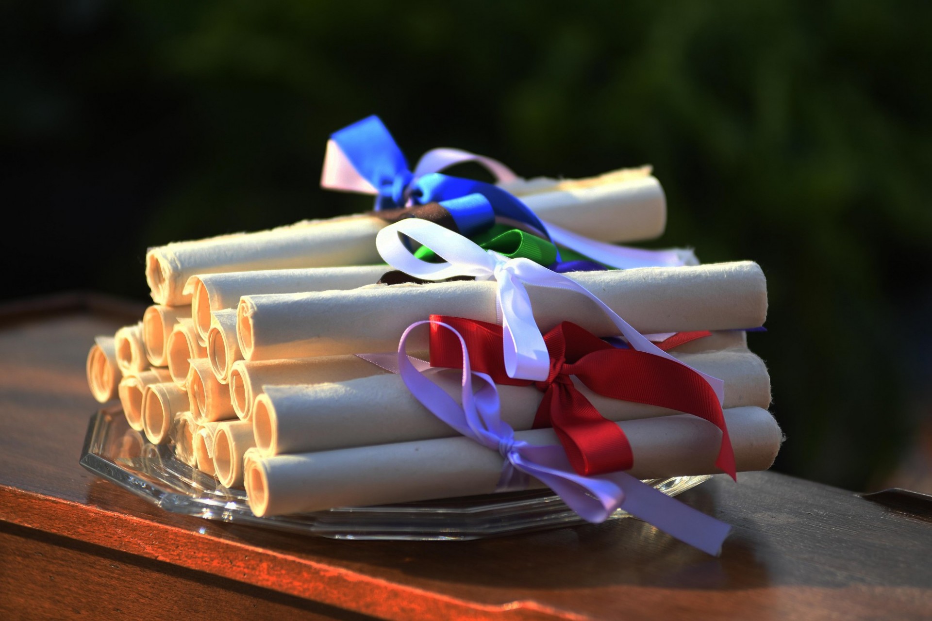 Stack of rolled award certificates wrapped in ribbon.