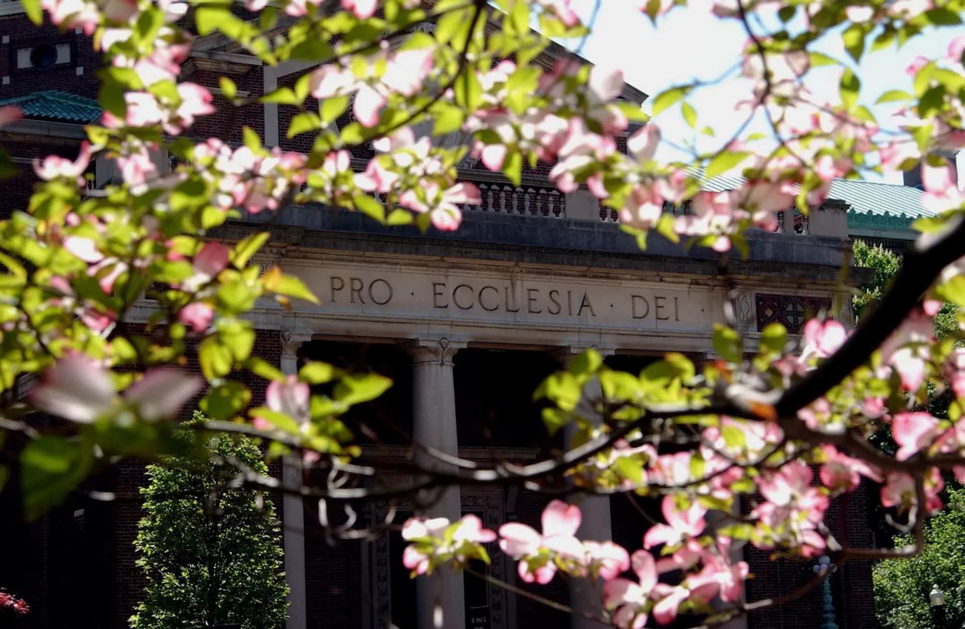 Picture of St. Pauls Chapel with spring blossoms in front.