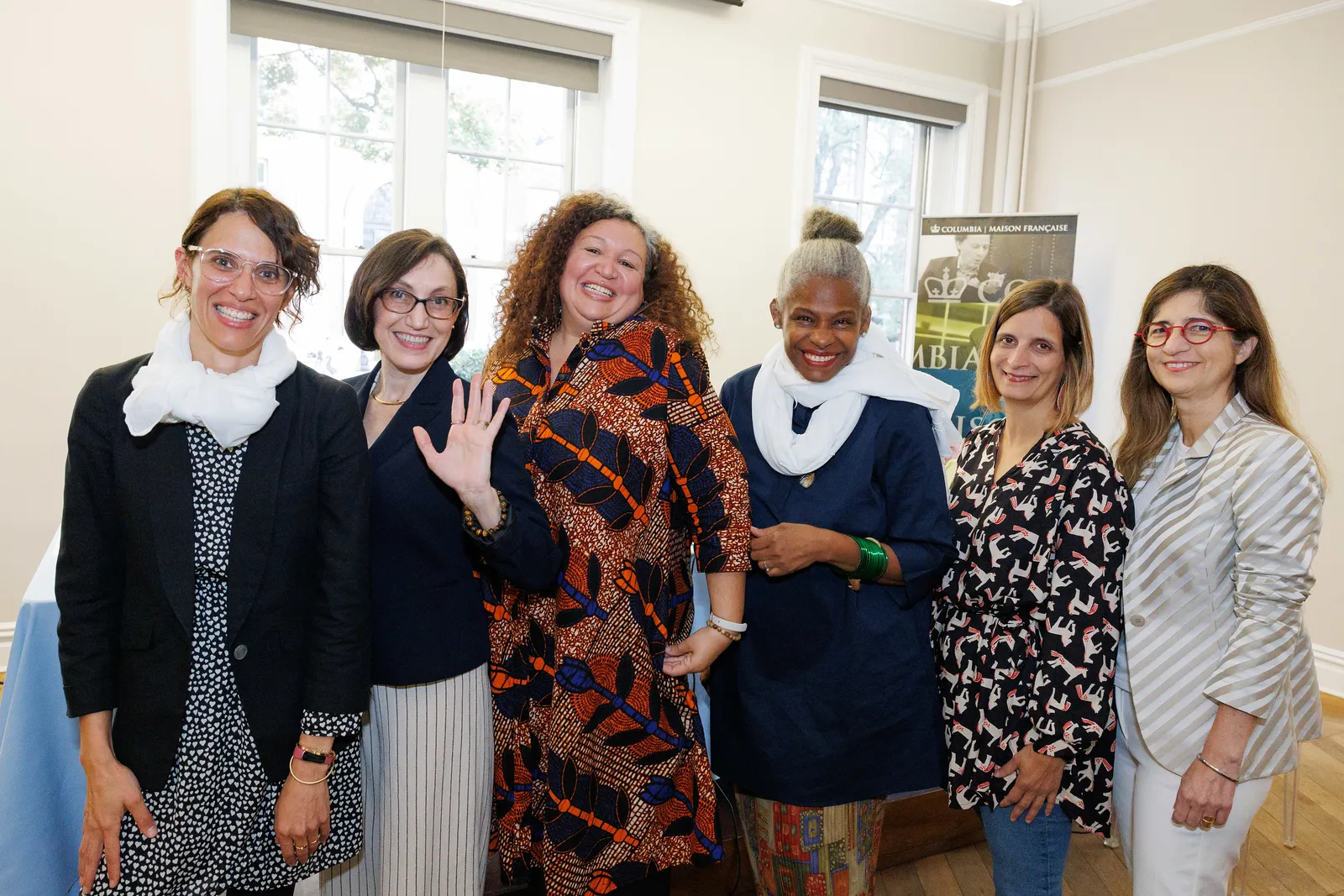 Photo of six women standing and smiling