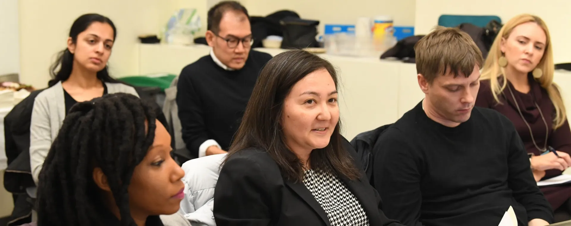 Photo of six faculty seated in classroom