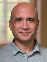 head shot of bruce western wearing a collared shirt