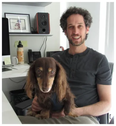 Photo of Andres Bendesky at his desk with his Dauschand