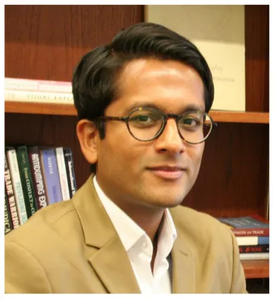 Head shot of Nikhar Gaikwad wearing tan suit