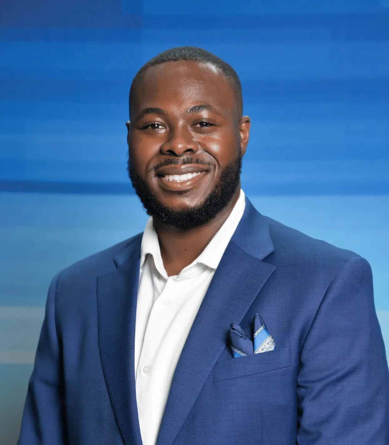 man smiling in front of blue background
