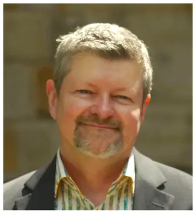 Head shot of George Chauncey wearing a striped shirt and gray suit jacket