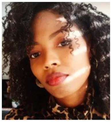 Head shot of Shanya Cordis with curly black hair