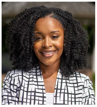Head shot of Natasha Johnson with curly shoulder length dark hair