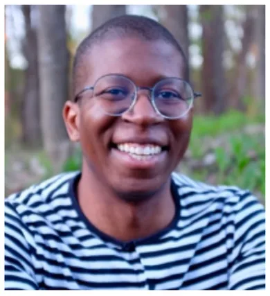 Head shot of David Knight wearing glasses and a horizontal striped shirt