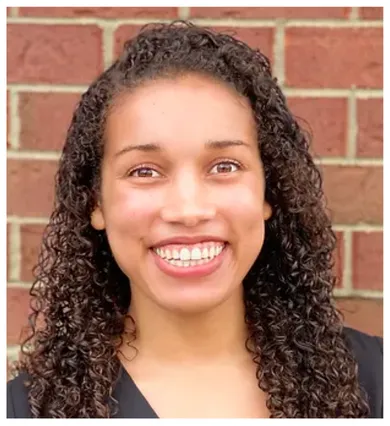 Head shot of Marissa Thompson in front of a brick wall