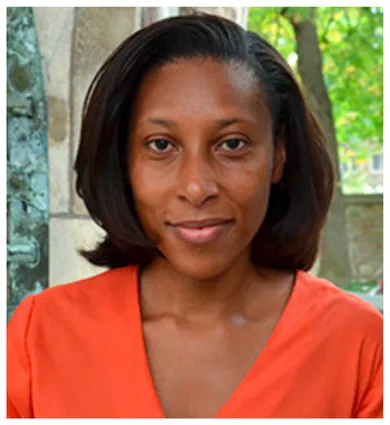 Head shot of Ebonya Washington wearing an orange v-neck shirt