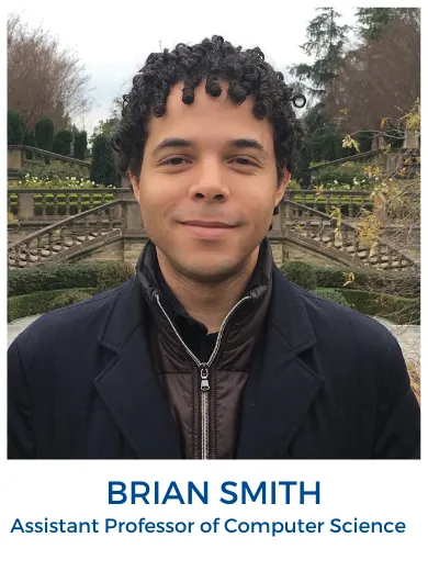 photo of Brian Smith wearing black jacket in front of a bridge