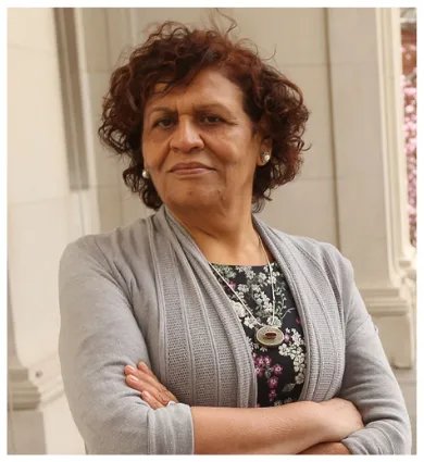 head shot of Nabila with arms crossed