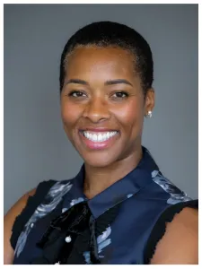 Head shot of woman smiling wearing a sleeveless shirt