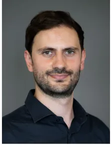 Head and shoulders view of man wearing dark shirt