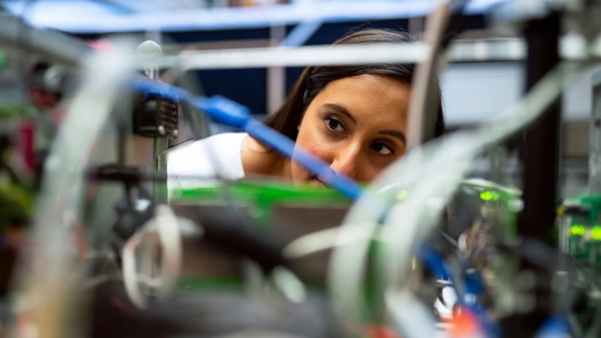 Photo of electrical engineer faculty looking through wires (stock image)