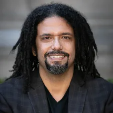 Photo of Frank Guridy with shoulder length dreadlocks