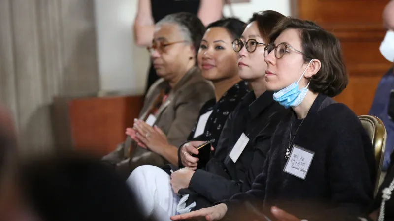 Photo of four women seated listening to the presentation