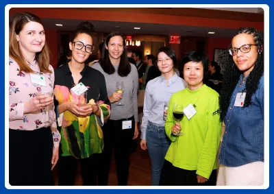 group photo of six women wearing name tags at a reception