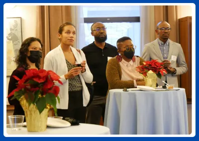 photo of faculty at a reception; two are masked