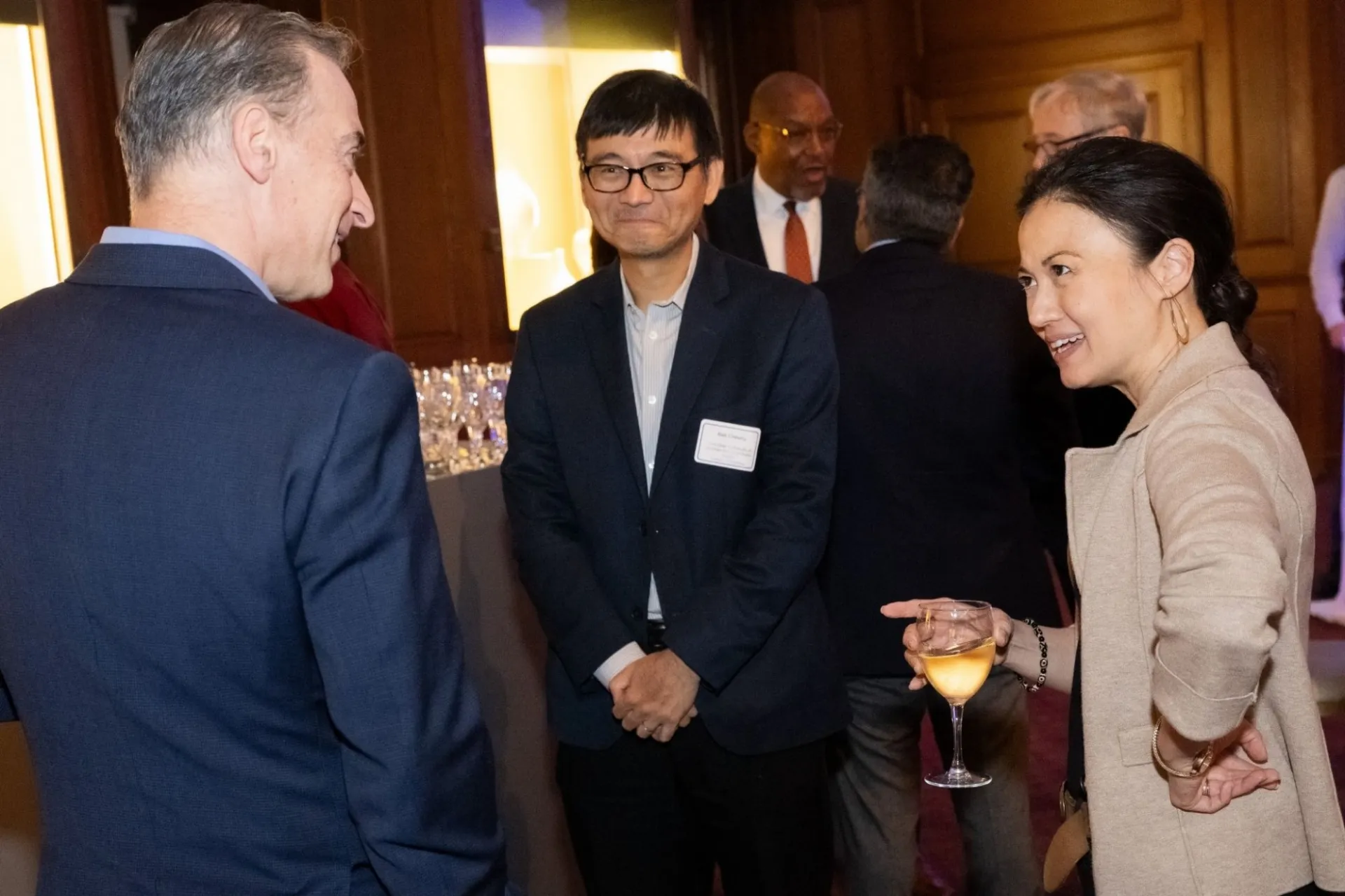 A group of people in business attire at a reception