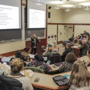 Professor lecturing to a class of engaged students