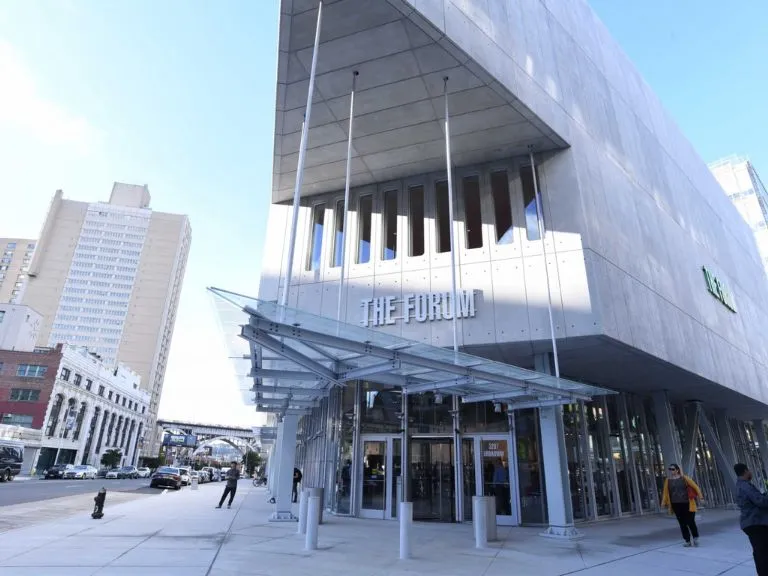 Modern entrance to an angular building with a sign that says "The Forum"
